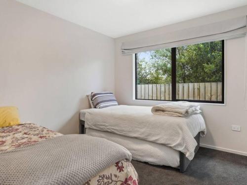 a bedroom with two beds and a window at Dumblane View in Hanmer Springs