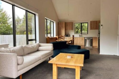 a living room with a couch and a table at Dumblane View in Hanmer Springs