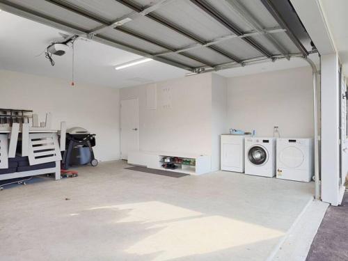 a garage with a washer and dryer in it at Dumblane View in Hanmer Springs