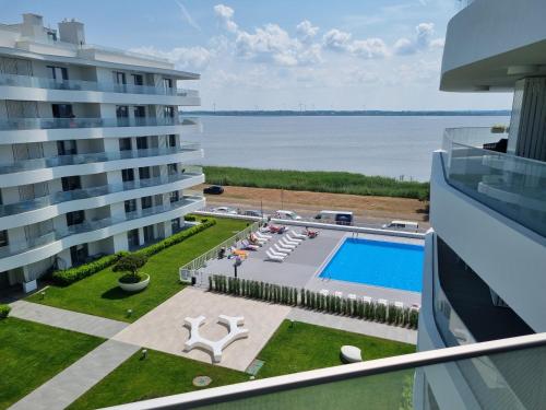 a view of the pool from the balcony of a building at Apartament Sapphire Rogowo Pearl in Mrzeżyno