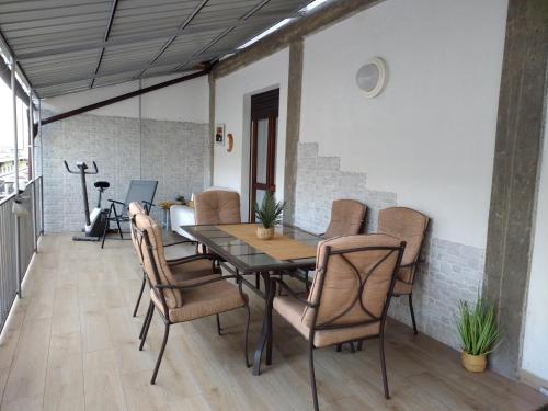 a dining room table and chairs on a patio at La Casina Sondrio Valtellina in Sondrio