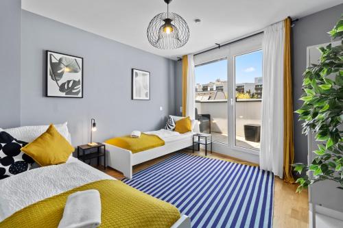 a bedroom with two beds and a large window at Long Term Stay - Near Klinik Floridsdorf - On-Site Parking for 19,90 Eur in Vienna