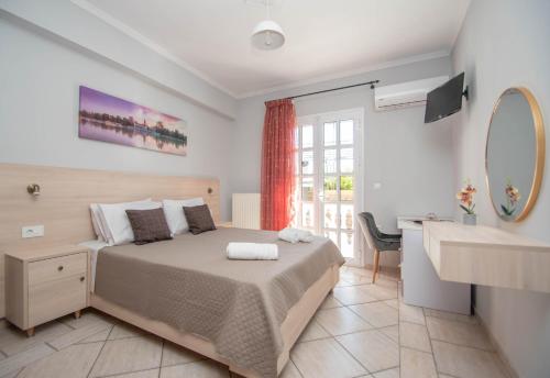 Villa Erato Family في Mouzákion: غرفة نوم بسرير ومغسلة ومرآة