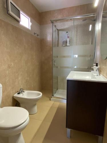 a bathroom with a toilet and a sink and a shower at City & Beach Top-Floor Apartment in Fuengirola