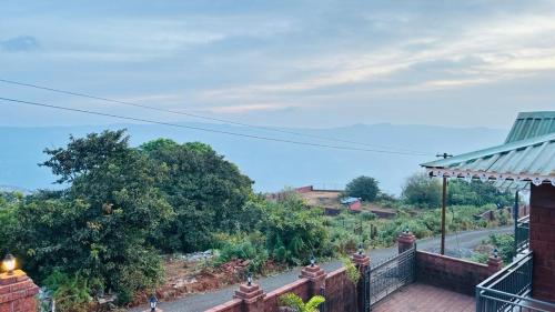 a view from the balcony of a house at Woodrose villa mahabaleshwar in Satara