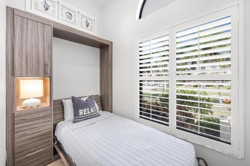a bedroom with a bed and a large window at Direct boating access waterfront home with pool/spa in Marco Island
