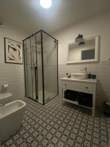 a bathroom with a shower and a sink and a tub at Palazzo Venezian 5 in Trieste