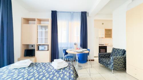 a room with a bed and a table and a chair at Le Due Farfalle by Ca-Sa Check in Chioggia