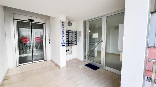 a hallway with glass doors in a building at Le Due Farfalle by Ca-Sa Check in Chioggia