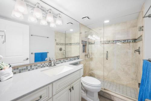 a bathroom with a toilet sink and a shower at South Seas Tower 4-704 in Marco Island