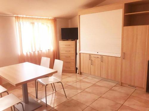 a dining room with a table and white chairs at Hotel Park in Rossano