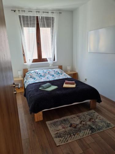 a bedroom with a bed with two towels on it at OLD TOWN ROAD in Karlovac