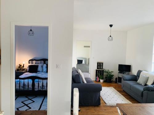 a living room with a couch and a bed at Maison de l'enfant gites 