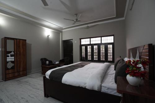 a bedroom with a large bed and a window at Sun flower Residency in Greater Noida