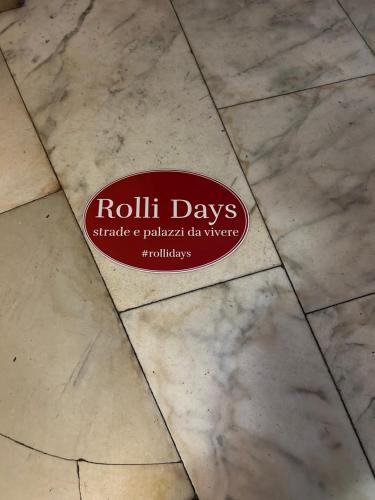 a sign that says roll days on a tile floor at Le Colonne Di San Luca in Genova