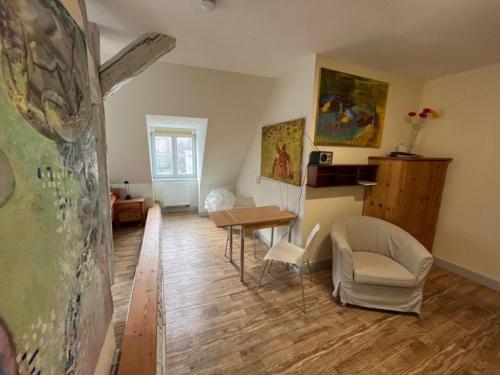 a living room with a table and a chair at 2 Ferienwohnung - Ferien Mittendrin in Schwerin