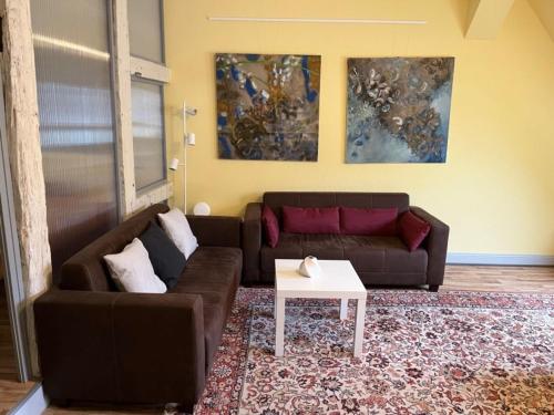 a living room with a couch and a table at 4 Ferienwohnung - Ferien Mittendrin in Schwerin