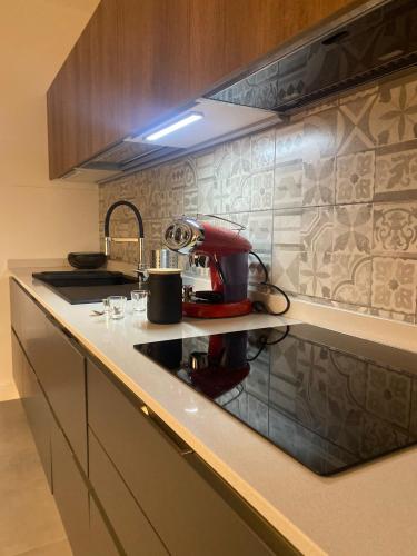 a kitchen with a coffee maker on a counter at Palazzo Venezian 5 in Trieste