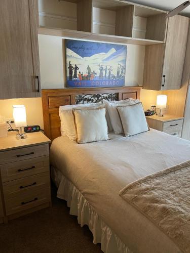 a bedroom with a large bed with two lamps on it at Pitkin Creek #7H in Vail