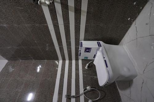 an overhead view of a toilet in a bathroom at Sun flower Residency in Greater Noida