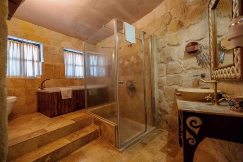 a bathroom with a shower and a sink at Mithra Cave Hotel in Goreme