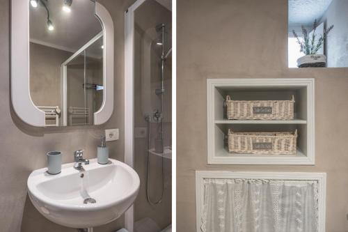 a bathroom with a sink and a mirror at "Casa Tarconte" nel cuore di Cortona in Cortona