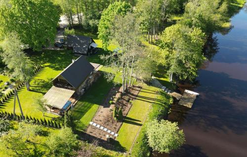 an aerial view of a house next to a lake at Joosepi Holiday House in Silla