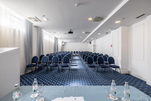 a conference room with chairs and a table with wine glasses at Art Hotel in Split