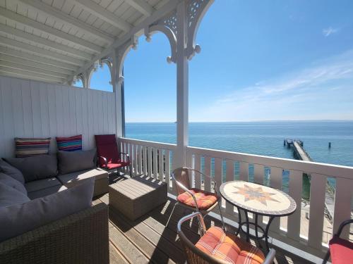 a balcony with a couch and a table and chairs at Fürstenhof - Ferienwohnung 204 in Sassnitz