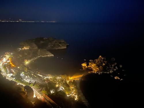 an aerial view of a city at night at Appartamento Georgiana in Taormina