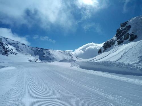 a snow covered mountain with a road in the middle at FW Schnuckel in 300a Altem Bergbauernhaus 1110m in Plessnitz