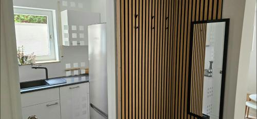 a kitchen with white cabinets and a sink and a window at Ferienwohnung Auszeit in Calw