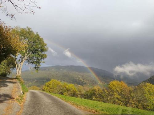a road with a rainbow in the middle of it at FW Schnuckel in 300a Altem Bergbauernhaus 1110m in Plessnitz