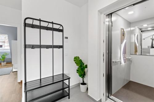 a bathroom with a glass shower stall and a plant at Long Term Stay - Near Klinik Floridsdorf - On-Site Parking for 19,90 Eur in Vienna