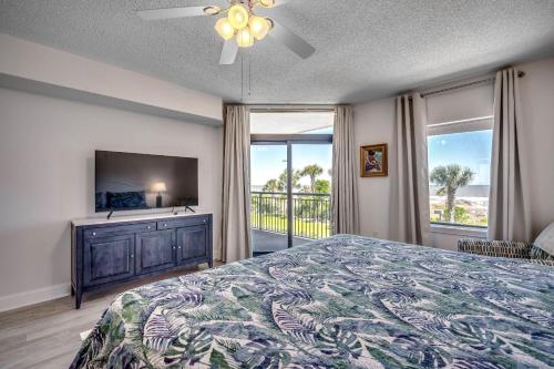 sypialnia z łóżkiem, telewizorem i balkonem w obiekcie South Wind 207 w mieście Myrtle Beach