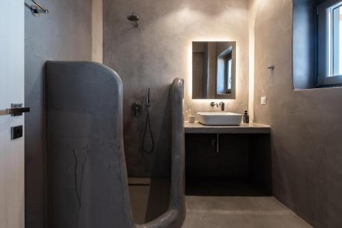 a bathroom with a sink and a mirror at Villa Lenny in Parikia