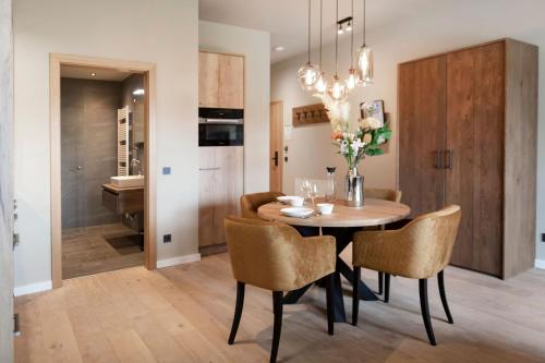 a kitchen and dining room with a table and chairs at Residenz Illyrica Tirol in Westendorf