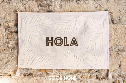 a sign for a hotel hanging on a stone wall at Gook Home CENTER in Jerez de la Frontera