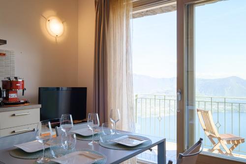 a dining room with a table with wine glasses at Artemisia in Parzanica