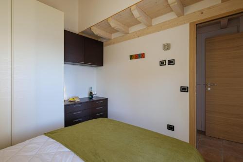 a bedroom with a bed and a wooden ceiling at Artemisia in Parzanica