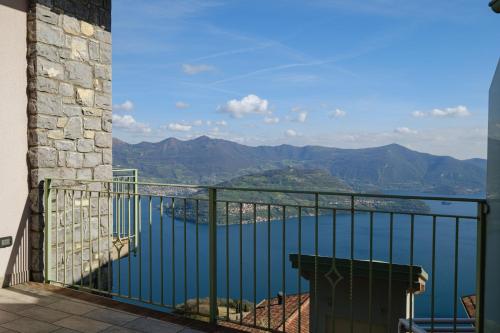 a balcony with a view of a body of water at Artemisia in Parzanica