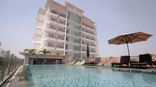 a hotel with a swimming pool in front of a building at Solia Hotel Yosodipuro in Solo