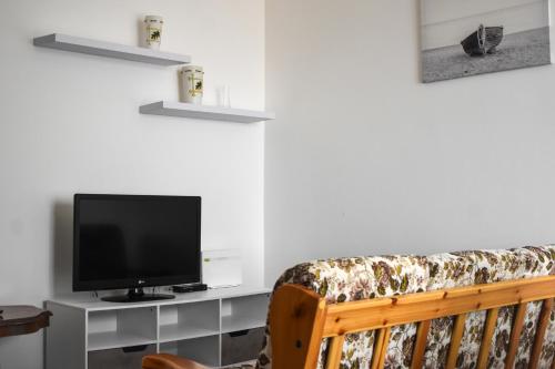a living room with a tv and a couch at Ciceri Properties Monte Zeda in Verbania