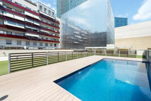 a swimming pool in front of a building at GuestReady - Living a dream in Barcelona in Barcelona