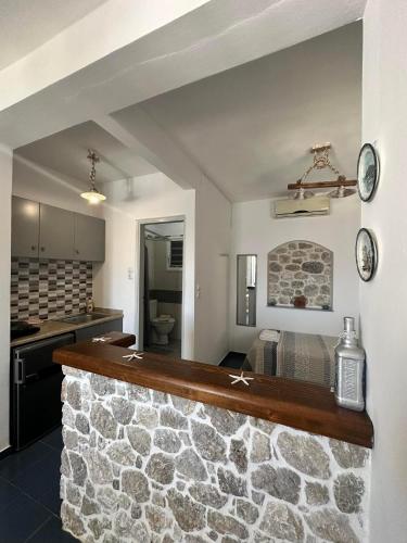 a kitchen with a stone counter in a room at Elenis Studios&Apartments in Masouri