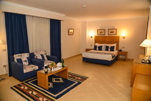 a hotel room with a bed and a couch at Eagles down town Zahabia &Beach Resort in Hurghada