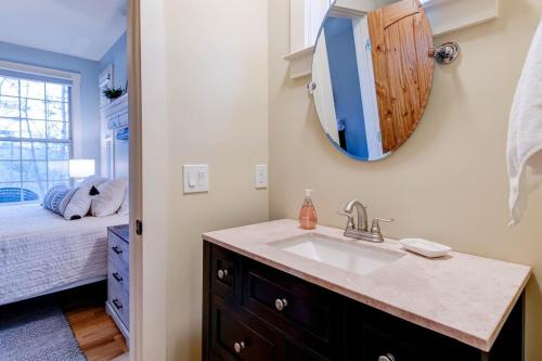 a bathroom with a sink and a mirror at Game Room ~ Fire Pit ~ Resort Access ~ Huge Home in Lake Lure