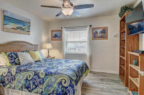 a bedroom with a bed and a ceiling fan at Buena Vista at Sea Isle Village in Port Aransas