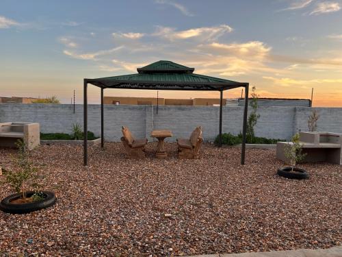a gazebo with a table and chairs under it at Mafikeng Boutique Lodge in Mahikeng