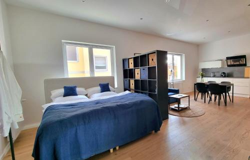 a bedroom with a large bed and a dining room at Design Apartment in Göttingen in Göttingen